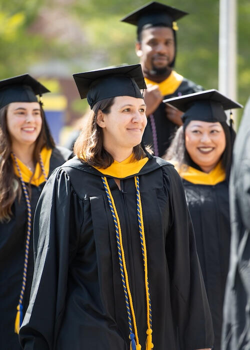 Melanie and grads at Commencement. Photo by UMPI / Dave Allen / Becky Shea